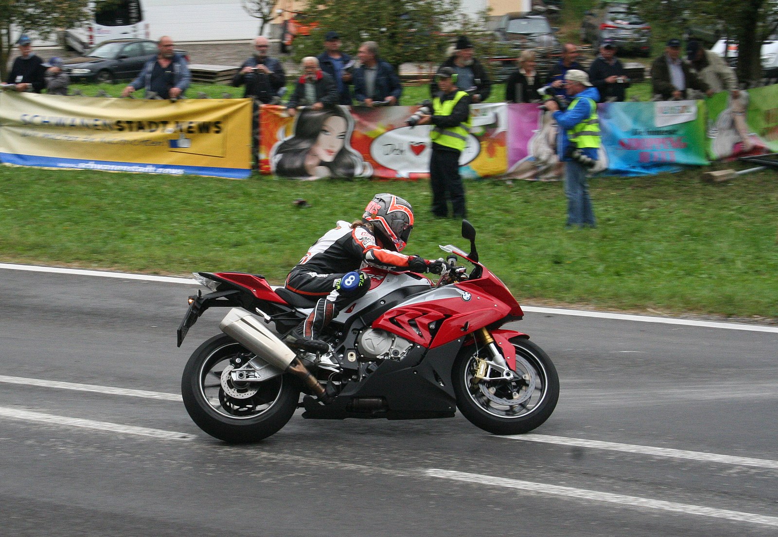 Maria Costello rides a red BMW S 1000RR at the Oldtimer Grand Prix in Austria in 2016