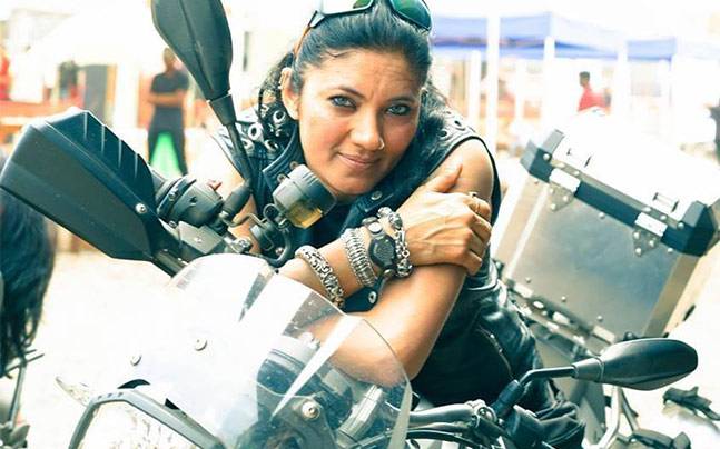 Veenu Paliwal, pioneering female Indian motorcycle rider sits on her Harley Davidson